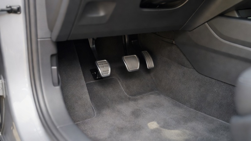 The pedals in the footwell of a manual car