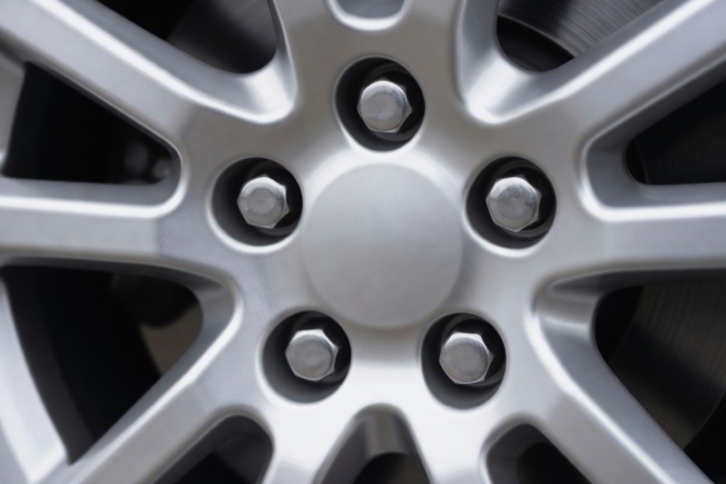 The centre of an alloy wheel showing the wheel nuts